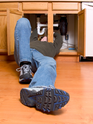 man under sink